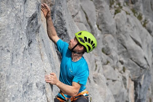 A climber conquers a sport climbing route. 